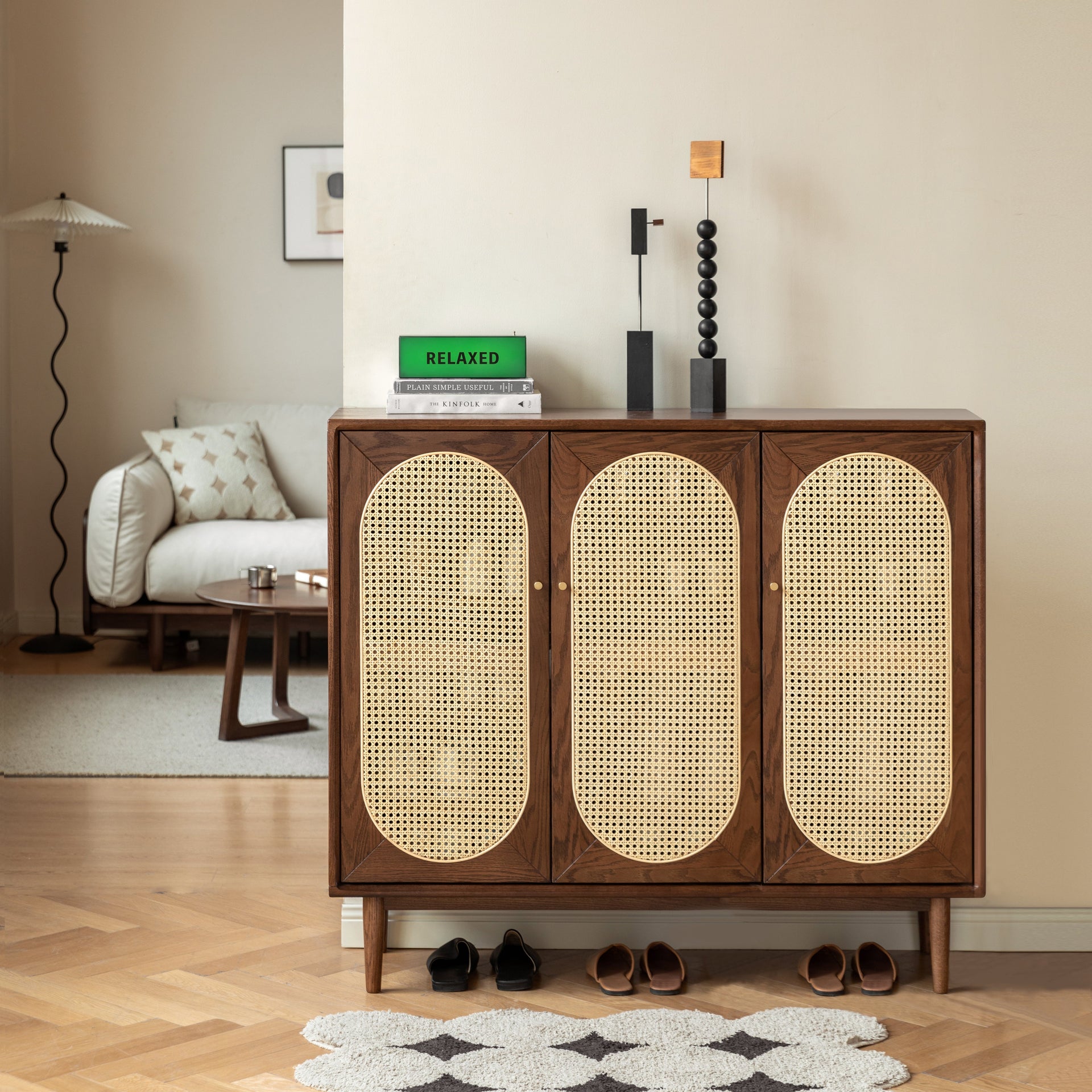 Wooden cabinet with wicker doors in a living room setting. Alwyn Shoe Cabinet Natural Solid Oak 110cm