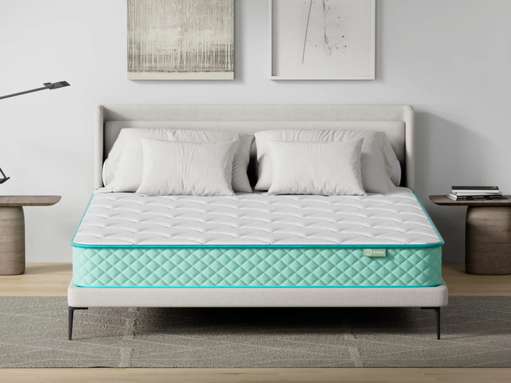 Mattress on a bed in a bedroom setting with decor elements.